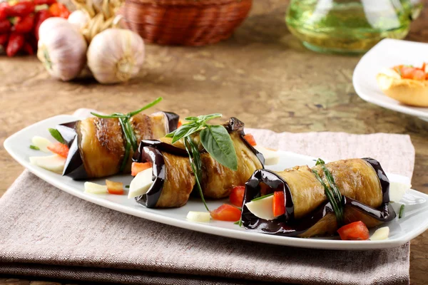 Eggplant rolls with cheese, tomato and basil — Stock Photo, Image