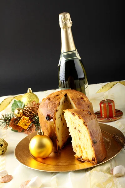 Table with panettone and christmas decorations — Stock Photo, Image