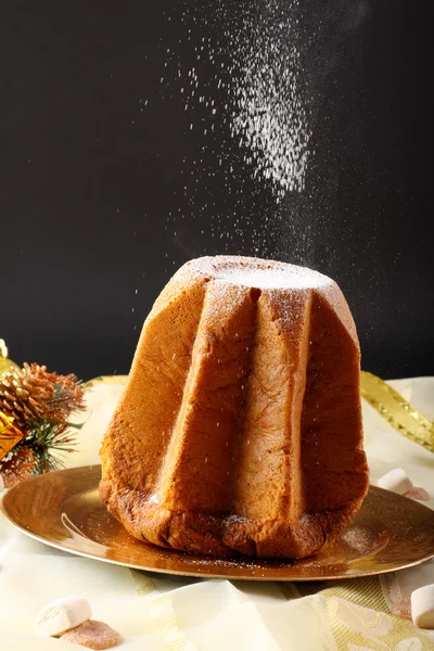 Pandoro Christmas cake on decorated table on complex background — Stock Photo, Image