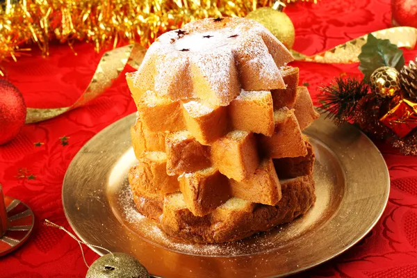Pandoro Christmas cake on decorated red table — Stock Photo, Image