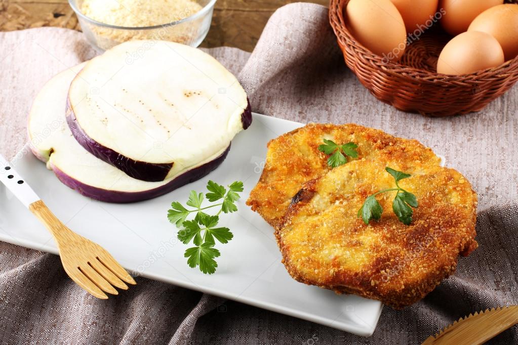 Eggplant cutlet with beaten egg and breadcrumbs Stock Photo by