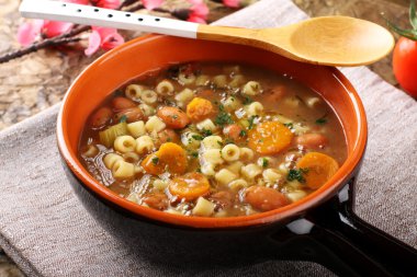 Bean soup in earthenware bowl clipart