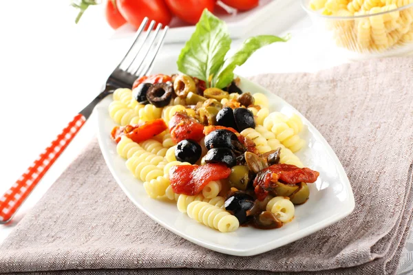 Pasta with olives, capers and tomatoes — Stock Photo, Image