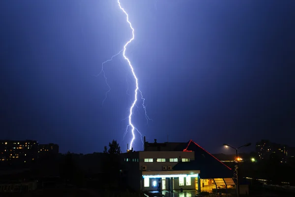 Severe lightning storm over a city buildings