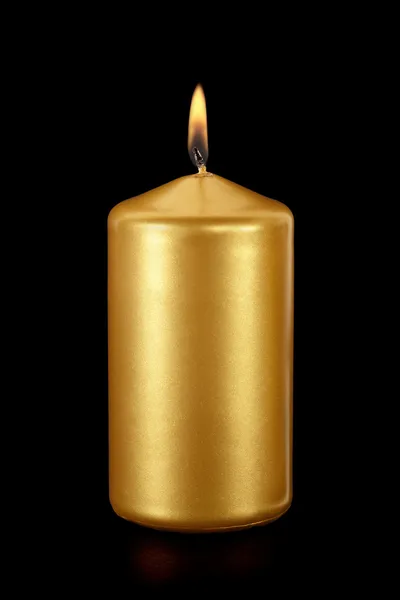 Golden candle lit on black — Stock Photo, Image