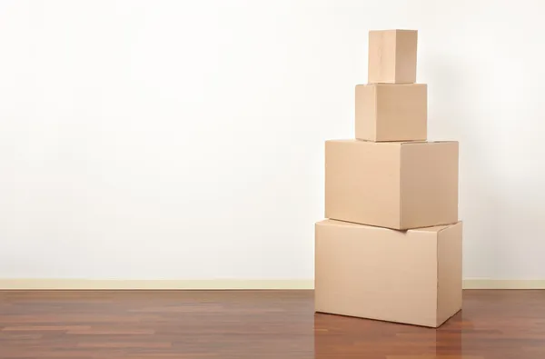 Cardboard boxes stack in apartment, moving day — Stock Photo, Image