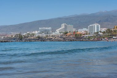 Playa de Troya, Costa Adeje, Tenerife, Canary Islands, Spain - May 1, 2022: view of the several imposing seafront hotels lining up the 10 kilometers long promenade connecting the main southern resorts