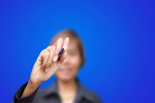 Business woman writing with blue marker pen on virtual screen — Stock Photo, Image