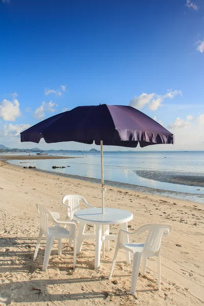 Beach chairs and umbrellas on beautiful tropical sand beach Stock Image