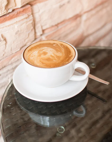 Hot coffee latte cup on glass table — Stock Photo, Image