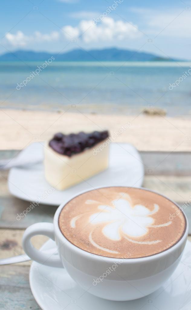 Coffee cup and cake on terrace