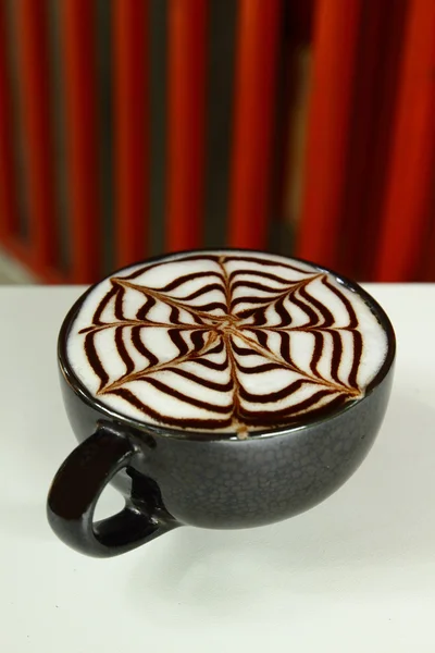 Cup of hot latte art in red vintage background — Stock Photo, Image