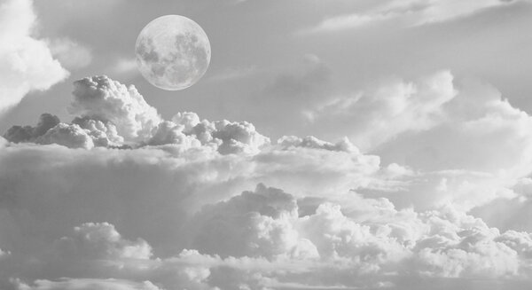 Dramatic moon over white cloud