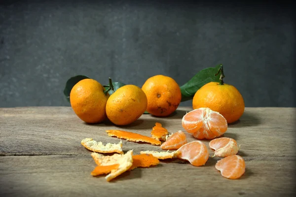 Still life with orange fruites on wooden table — Stock Photo, Image