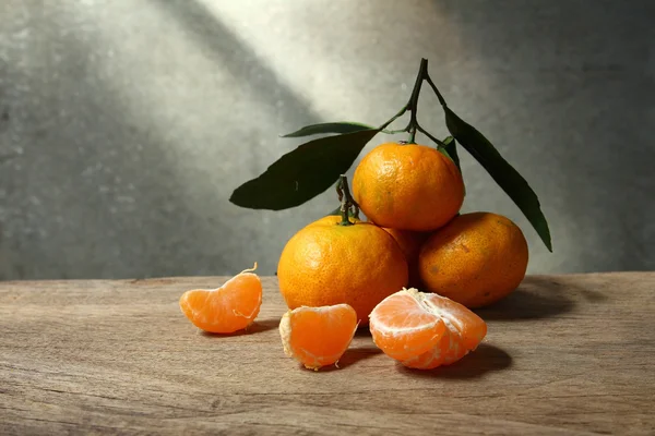 Still life with orange fruites on wooden table — Stock Photo, Image
