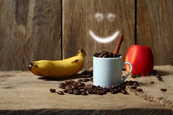 Coffee beans, banana and apple — Stock Photo, Image