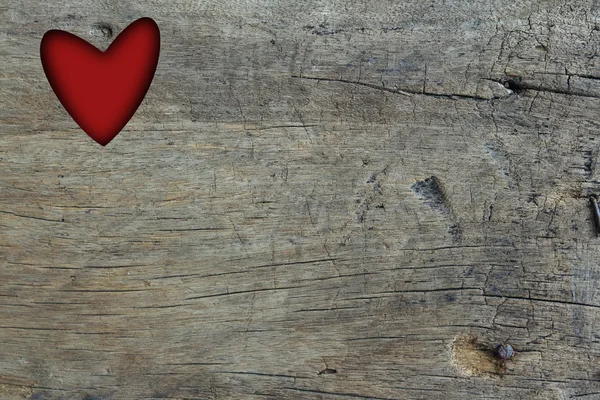 Otwór o kształcie serca czerwony na drewno tło grunge — Zdjęcie stockowe