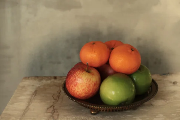 Still life apples and orange fruit on bronze tray in vintage style — Stock Photo, Image