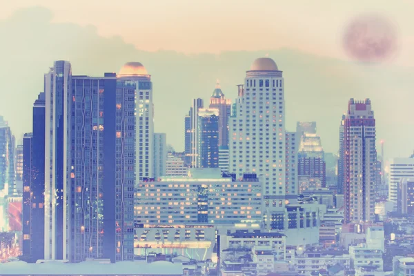 Aerial view of Bangkok cityscape at night with full moon backdrop — Stock Photo, Image