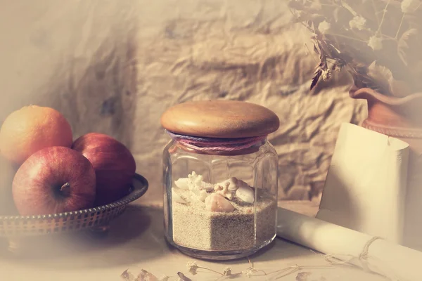 Still life with seashell,dry roses ,grunge paper and fruits on wooden table — Stock Photo, Image