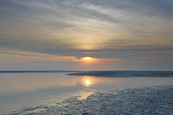 Alba sulla spiaggia con cielo e mare drammatici — Foto Stock