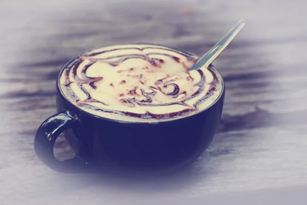 Cup of coffee latte art on grunge wood table in vintage style — Stock Photo, Image