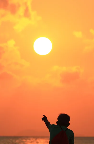 Silhuetten av en biker beach, pekar på sunset — Stockfoto