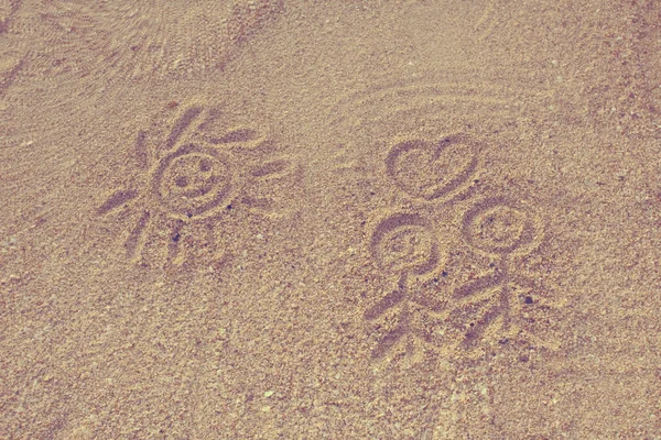 Smiling sun drawn on sand — Stock Photo, Image