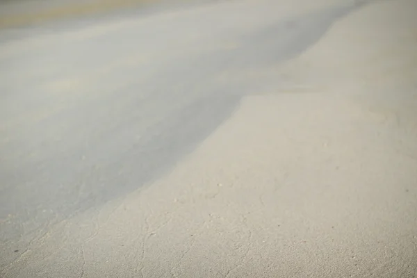 Arena de playa texturizada útil para el fondo, dof poco profundo — Foto de Stock