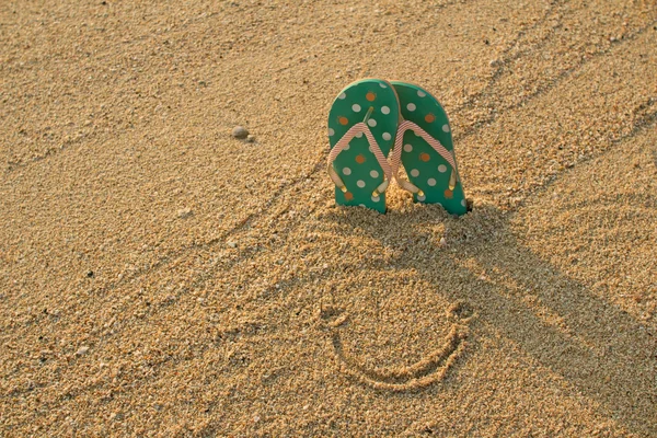 Flip flops and smile on sand — Stock Photo, Image