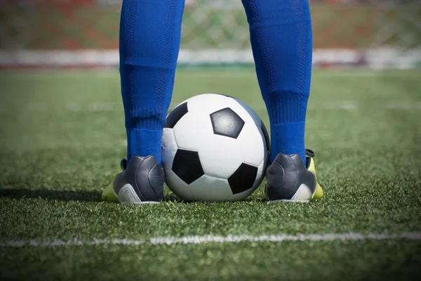Soccer player's feet on ball — Stock Photo, Image