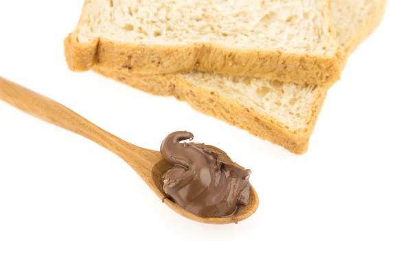 Шоколад подается на деревянной ложке и хлеб изолирован на белом — стоковое фото