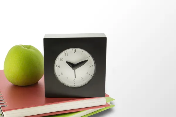 Clock,apple fruit and notebooks on white background — Stock Photo, Image