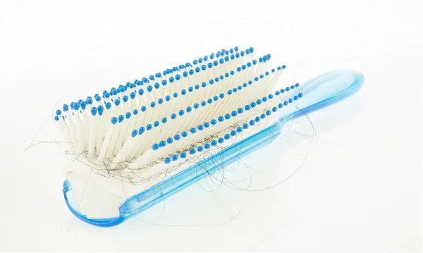 Hairbrush with lock of hair lost  on white background — Stock Photo, Image