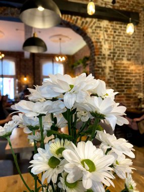 Ön planda çiçekler olan bir kafe.