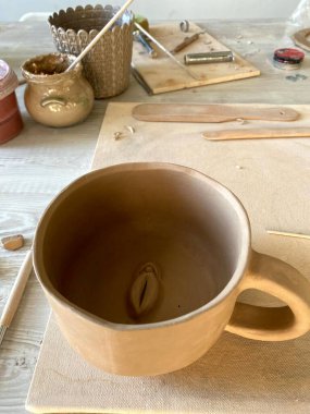 clay for pottery and mug, mug with vagina, clay vulva