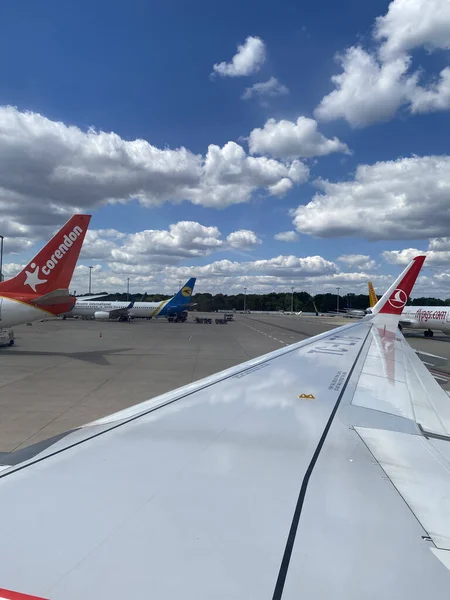 The wing of airplane at airport. View from aircraft window. Istanbul Airport, Turkish Airlines Flying Aircraft