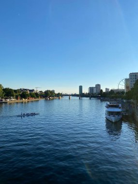 Frankfurt, Germany: River view of The Eiserner Steg. The Eiserner Steg is a pedestrian bridge in Frankfurt am Main built in 1868. City skyline in Frankfurt, Germany.
