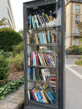 Frankfurt, Germany: public bookcase for borrowing and exchanging used books free of charge next to a store in the city center