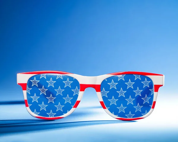 Cool red, white, and blue sunglasses in the pattern of the US American flag. For USA 4th of July or other patriotic celebrations.