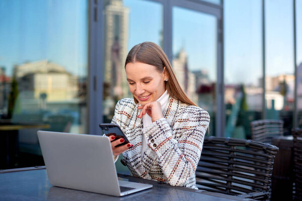 self employed business woman work remote on laptop in city cafe