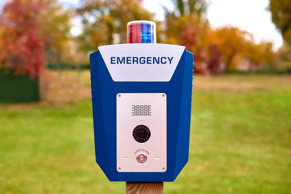 Panic alarm for call to police, emergency button in public park. Blue box with video camera and red blue warning light on top