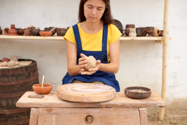 Potter with wet clay pot in hands. pottery hobby woman hands sculpt in clay