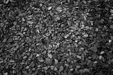 Thousands of pieces of cracked slate, small gray stones lie on the ground, floor