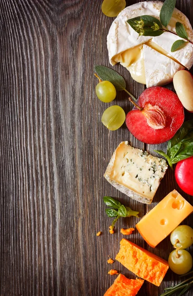 Cheeses and fruit. — Stock Photo, Image