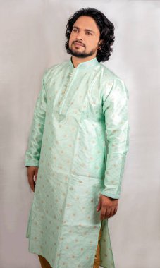 young indian male wearing green kurta side pose