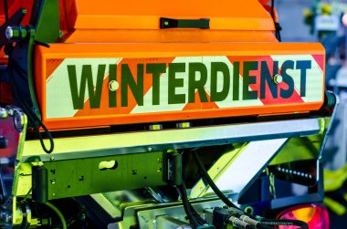 Winter service (Winterdienst) inscription on the snow blower car clipart