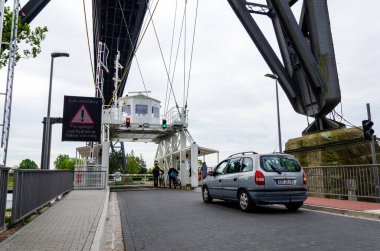 Rendsburg, Almanya - 11 Mayıs 2022: Rendsburg Taşıyıcı Köprüsü (Schwebefaehre). Köprünün altındaki sallanan feribot... .