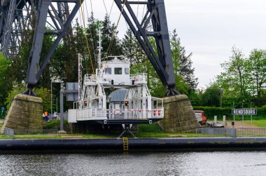 Rendsburg, Germany - May 11, 2022: Rendsburg Transporter Bridge (Schwebefaehre). The hanging ferry under the bridge span .