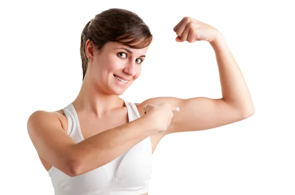 Ten obecnie poiting kobieta w jej biceps — Zdjęcie stockowe